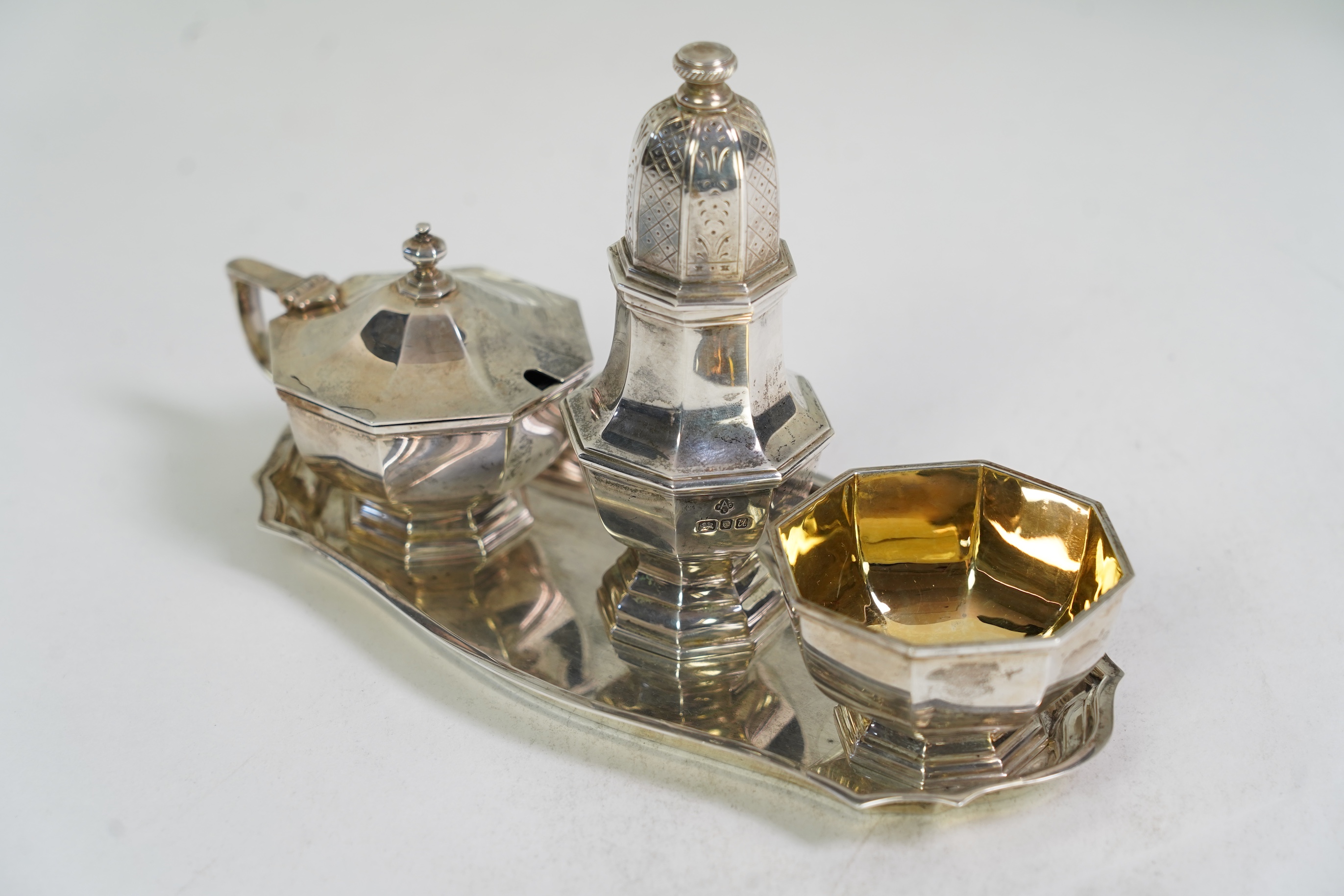 An Elizabeth II Asprey & Co silver three piece condiment set on stand